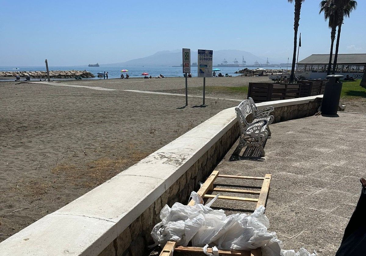 Mobiliario y palés tirados en el paseo marítimo.