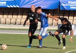 Javi Mérida, del Torremolinos, trata de llegar al balón.