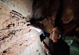Pedro Cantalejo muestra el conchero, en la zona menos virgen de la Cueva del Tesoro.