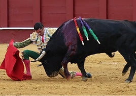 Emilio de Justo iniciando la faena al tercero de la tarde por bajo con una rodilla en tierra.