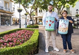 El concejal del distrito Oeste, Alejandro González, y la asesora responsable de Comercio, Carmina Serrano, posan con dos de las papeleras decorativas.