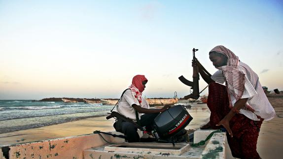 Piratas somalíes, armados, preparan un esquife, en la playa de Hobyo (Golfo de Adén).