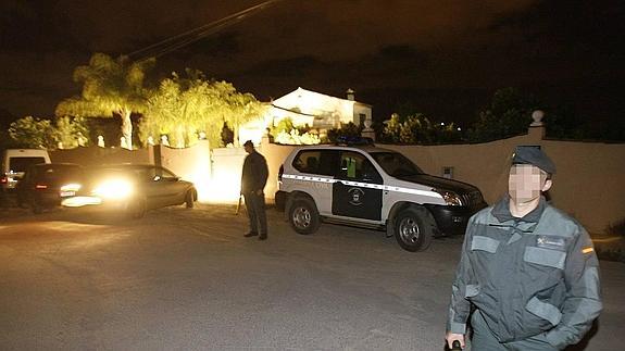 Agentes inspeccionan la finca tras la muerte de dos hombres. 