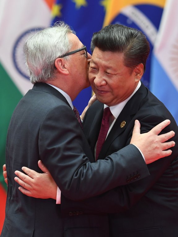 Juncker estampa un par de besos al presidente chino. :: AFP