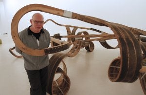 Richard Deacon posa junto a la escultura 'Out of order' (2003), realizada con madera de roble y acero. ::                             ÁLVARO CABRERA