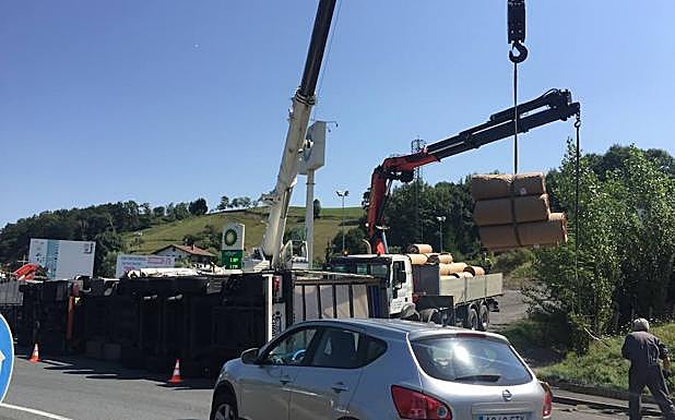 Una grúa retira la carga del camión siniestrado.