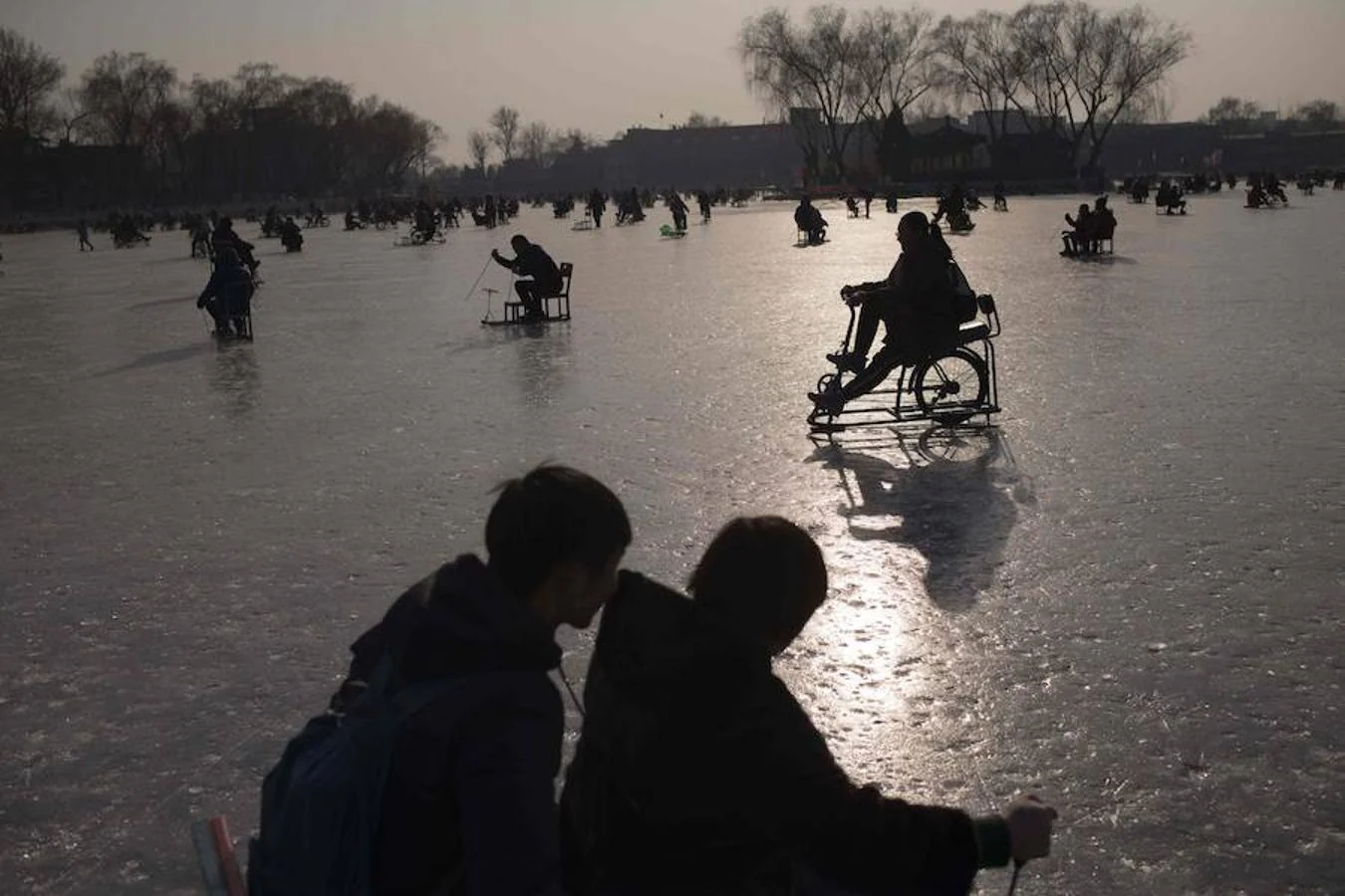 Familias disfrutan del patinaje sobre el congelado lago Hou Hai en Benijing antes del Año Nuevo Lunar. China marcará el comienzo del Año Nuevo Lunar el 16 de febrero, marcando el comienzo del Año del Perro.