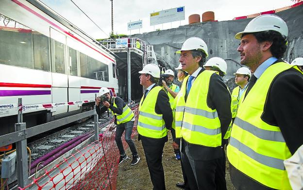 Autoridades observan el tren bajo la tuneladora que abre el gálibo en Gaintxurizketa.