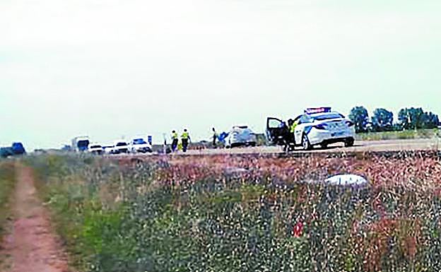 Policías y restos del accidente junto a la carretera N-601 de León, que transcurre en recta y es de doble sentido.