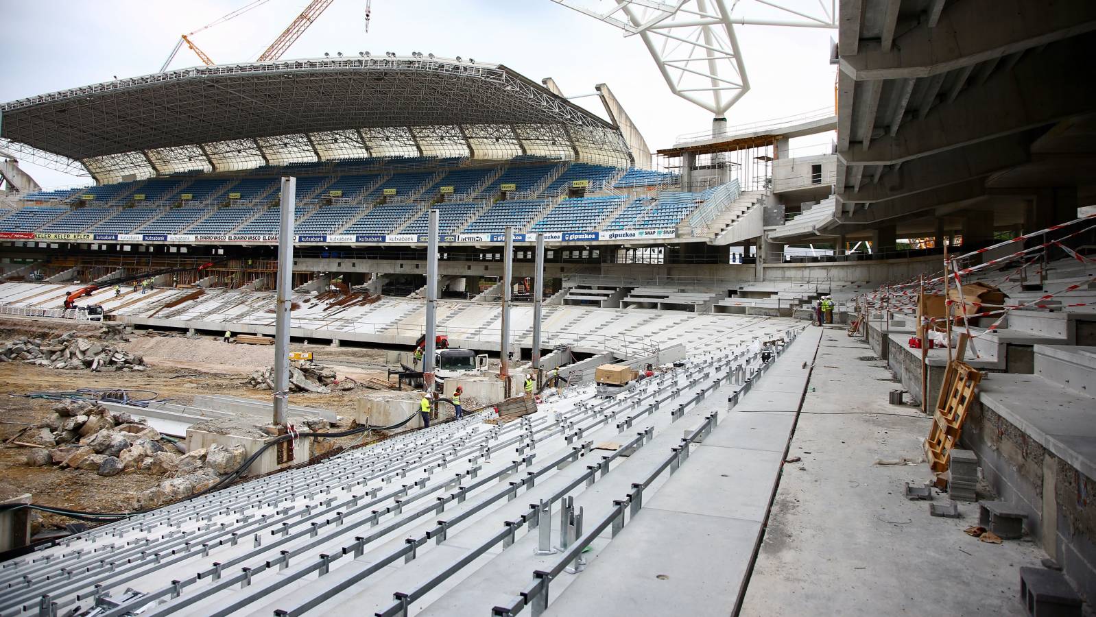 En los últimos días se está procediendo a bajar el terreno de juego de Anoeta y está previsto que el 31 de julio esté totalmente excavado para que se pueda proceder a la colocación de los paquetes del terreno de juego. Se están sellando las gradas en Anoeta y se han comenzado a colocar las bancadas sobre las que se colocarán los asientos. Por otro lado, empieza a verse tabiquería de aseos y bares, se están hormigonando las losas sobre las que se colocarán las gradas de tribunas bajas y también se sigue con los trabajos del zócalo este.