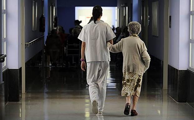 Una anciana con su cuidadora en una residencia vasca. 