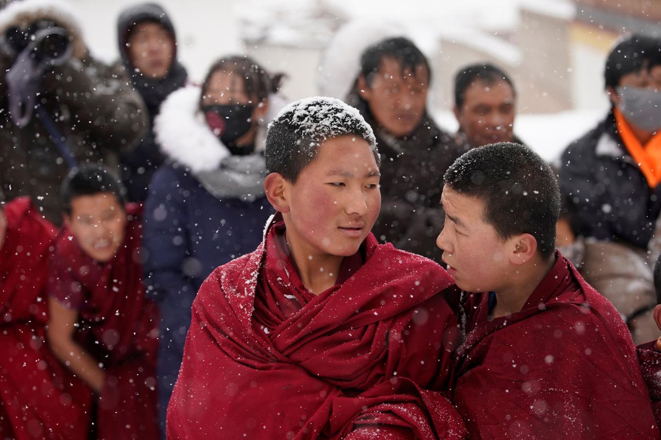 El frío y la nieve no impidió que los monjes tibetanos asistieran a una ceremonia en el Langmu Lamasery durante el 'Sunbathing Buddha Festival', el pasado domingo en la Prefectura Autónoma Tibetana de Gannan, provincia de Gansu, China.