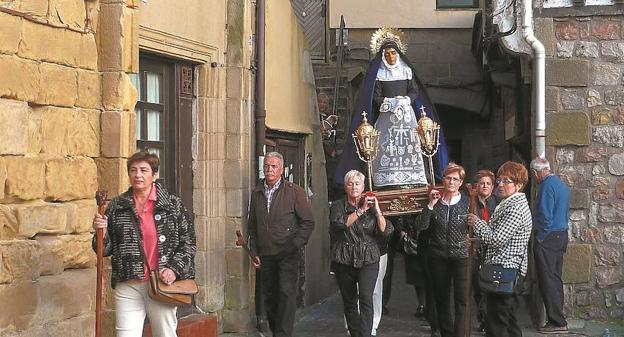 Por el casco antiguo. Las mujeres portan sobre sus hombros la imagen de La Dolorosa.