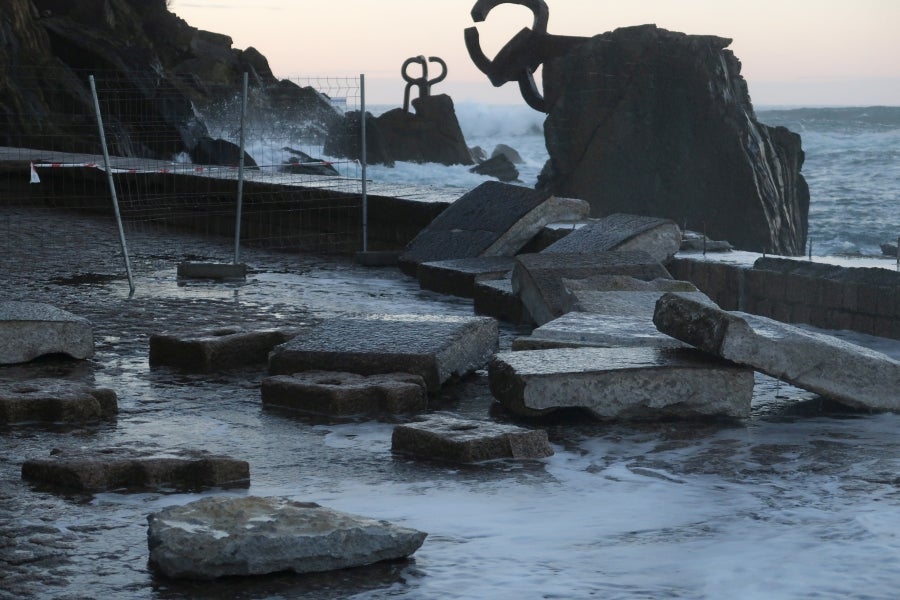Una parte del muro que cierra el acceso peatonal se ha derrumbado debido al fuerte oleaje de la zona. 