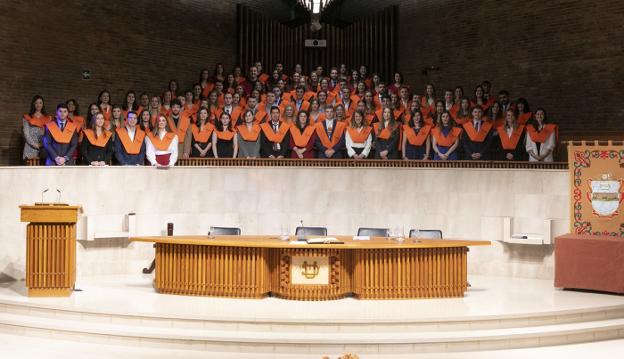 Los nuevos graduados posan tras recibir sus títulos universitarios. 