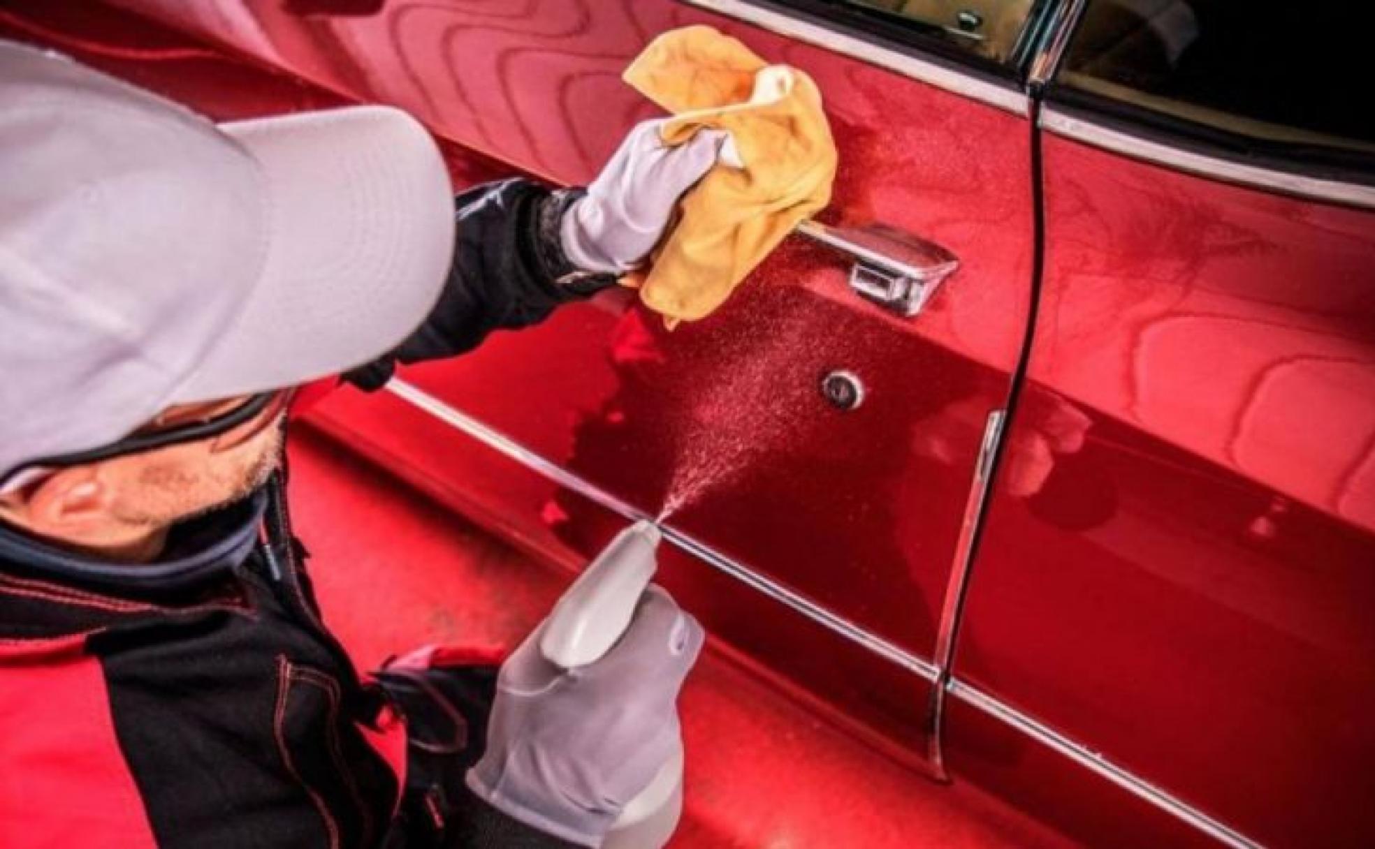 Dos operarios desinfectan un automóvil de coronavirus. 