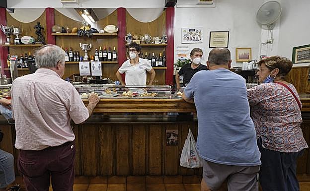 Varios clientes aprovechan en el Paco Bueno la última jornada en la que se podrá consumir de pie en las barras de los bares.