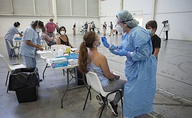 Operarios de Osakidetza realizan la PCR a vecinos de Irun en el pabellón de Ficoba. 