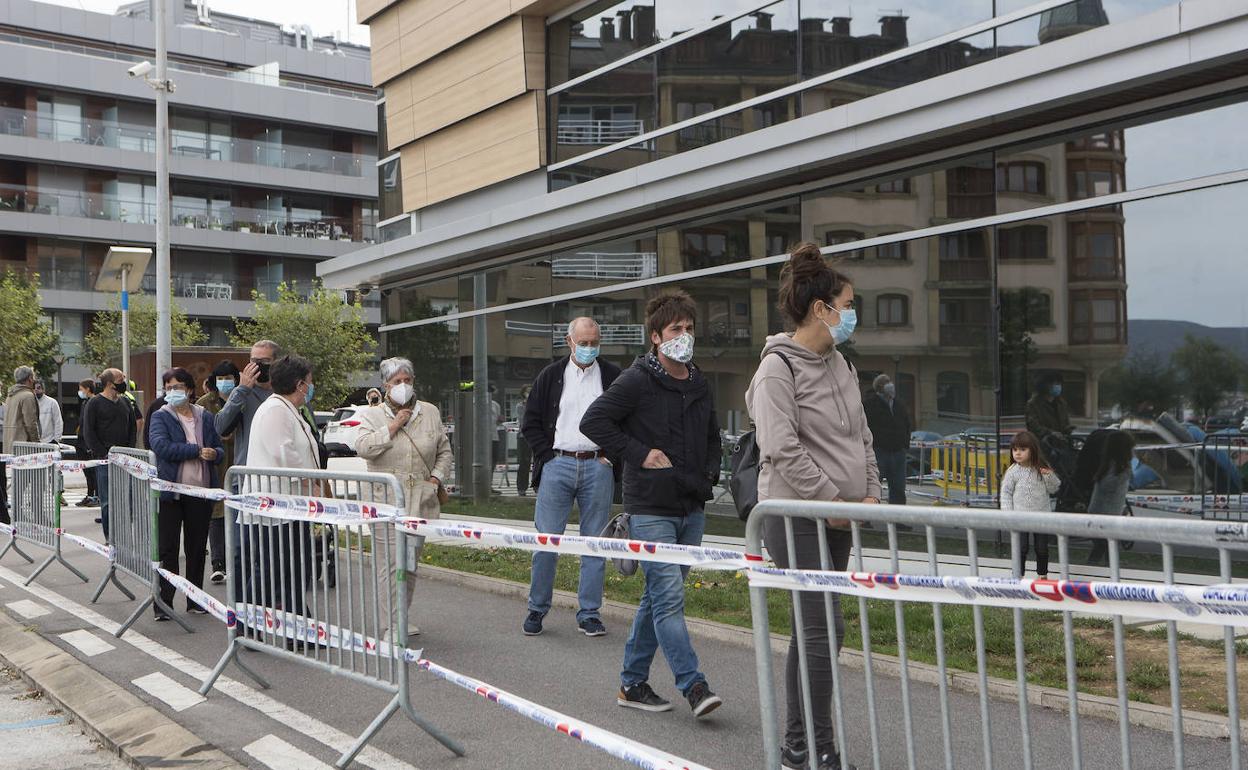 Varios ciudadanos aguardan en cola para someterse a una PCR en la Itxas Etxea de Hondarribia.