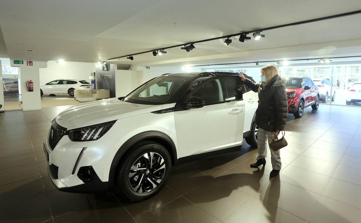 Una mujer inspecciona un vehículo en un concesionario de Oiartzun. 