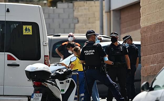 Varios agentes y vehículos de la Policía Local de Ceuta acompañan a menores no acompañados hacia una furgoneta