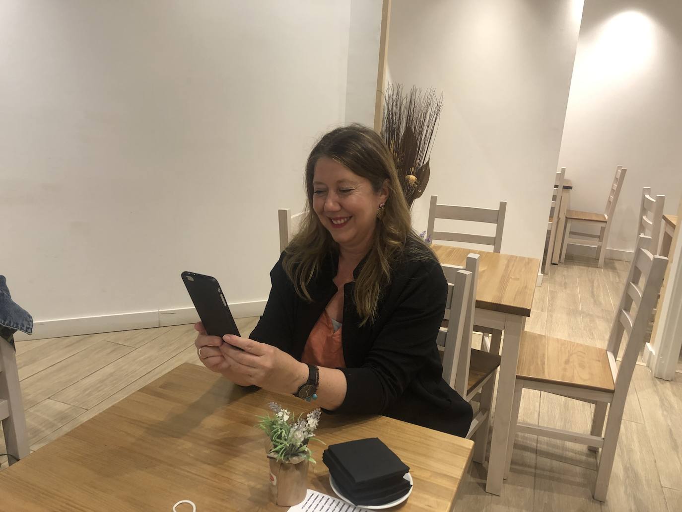 María Jiménez consulta la sección de Economía mientras espera en un restaurante.