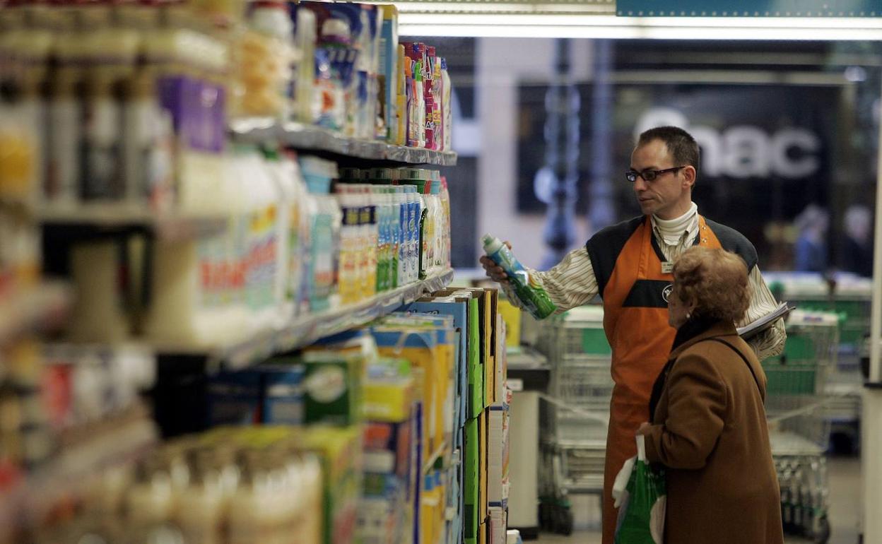 Un dependiente atiende en un supermercado. 