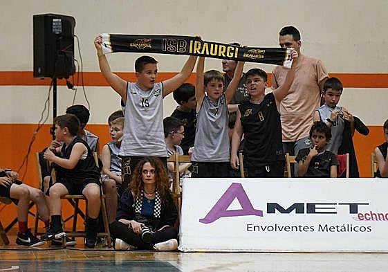 Tres jóvenes del Juaristi Iraurgi animan a su equipo en el polideportivo de Azpeitia.
