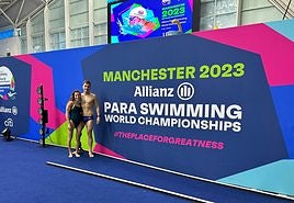 Nahia Zudaire e Iñigo Llopis, sonrientes delante del cartel anunciandor del Mundial de Manchester.