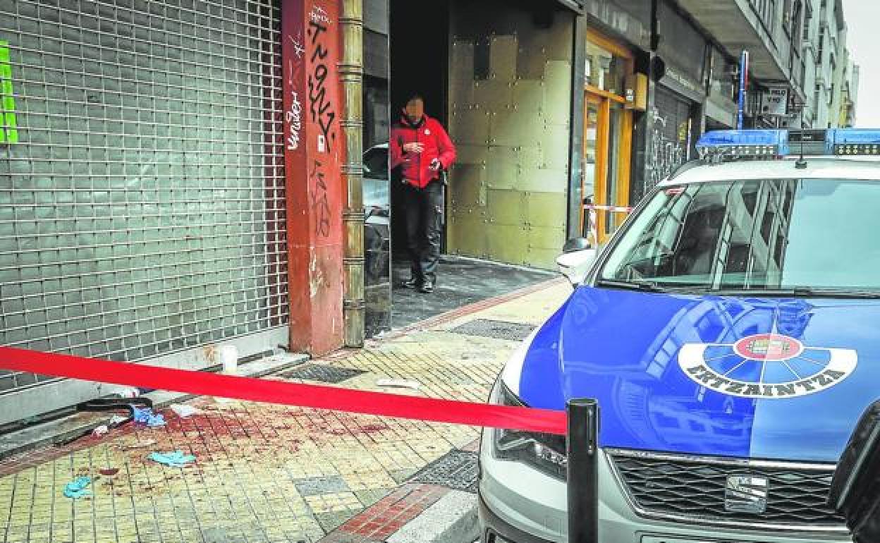 Agentes buscan evidencias en la puerta del local.