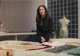 Paula Ulargui en su estudio de Madrid posando junto a las prendas que diseñó para la presentadora