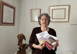 En la galería Armi, junto a algunas de sus obras expuestas y con algunos de sus libros.