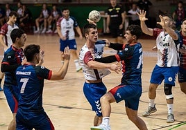Un jugador del Mek Eibar arma el brazo ante la defensa de un rival.