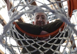 Moncho Fernández, sonriente apoyado en el aro de una canasta.