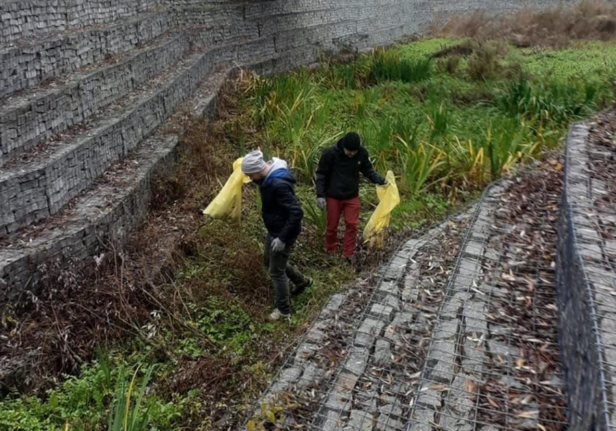 Las familias del barrio han tenido que adentrarse en el río en varias ocasiones para adecentarlo y retirar basuras.