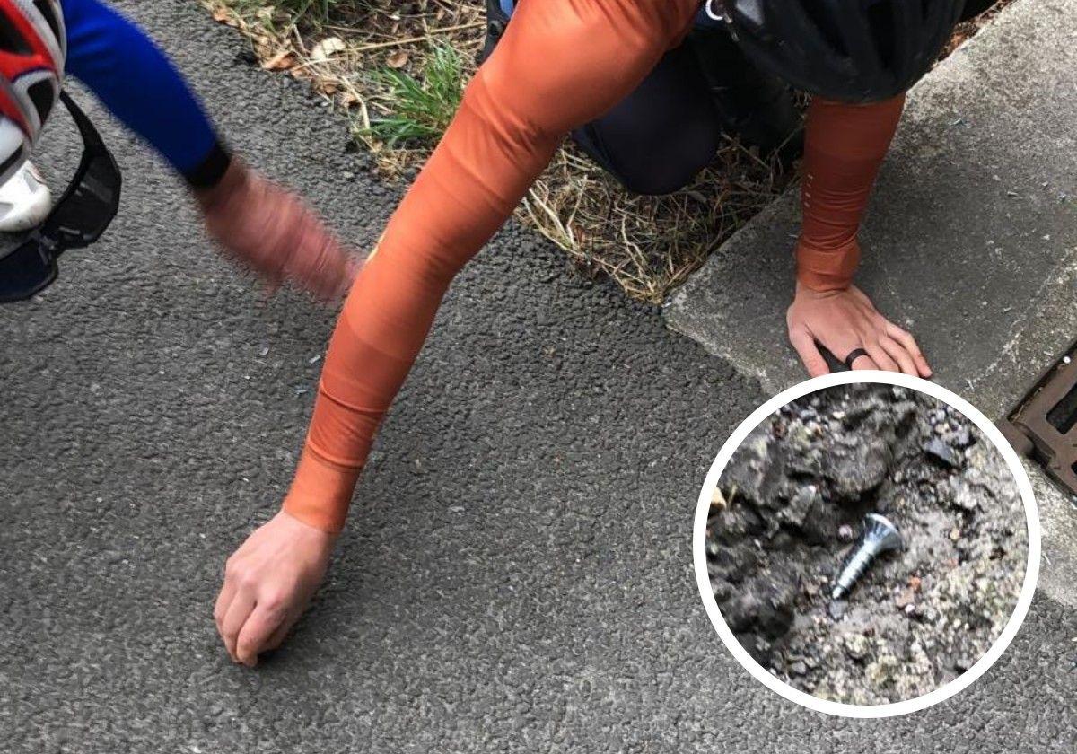 Dos cicloturistas retiran clavos del arcén en Usurbil, en el lugar en el que Iñaki Pakea sufrió un atropello mortal el lunes pasado.
