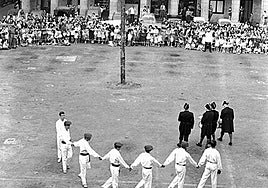 El tradicional baile del árbol de San Juan. Obsérvese que quedan automóviles estacionados al fondo.