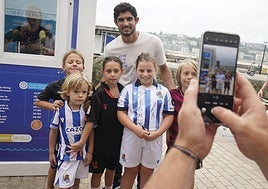 Guedes posa con aficionados realistas durante su presentación como jugador de la Real