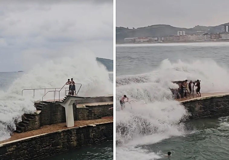 Varios bañistas asisten de cerca al espetáculo de las olas en Zarautz.