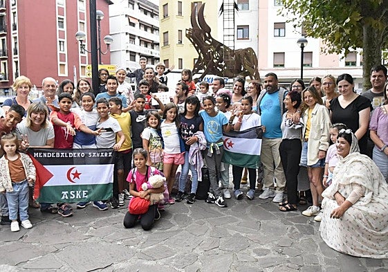 Las familias de acogida y los menoressaharauis posan juntos antes de despedirse.