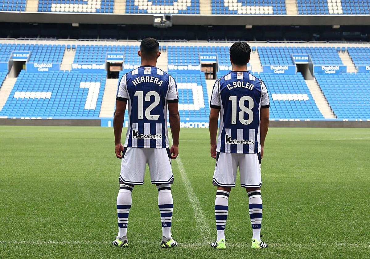 Yangel y Soler, los nuevos '12' y '18' de la Real posan con sus dorsales en Anoeta.