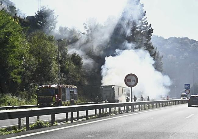Imagen de los bomberos en plenas labores de extinción del incendio en el remolque.