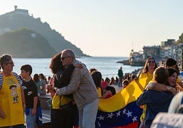 Dos personas se dan un abrazo en el mirador junto al Club Náutico de San Sebastián.