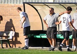 Iker Araneta abandona el césped de Asti tras ver la segunda amarilla mientras recibe el cariño de su entrenador Jaime Colado.