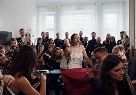 La Orquesta Sinfónica de Londres y miembros de los coros de la Escolanía de Montserrat y el Orfeó Català rodean a la cantante en un momento del nuevo clip.