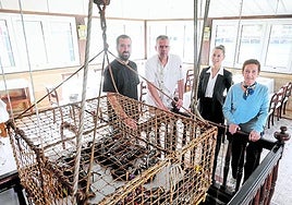 Los capitanes de Casa Cámara, ante el vivero de bogavantes y langostas del interior del local.