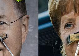 Peter Steinbrück y Angela Merkel en sus respectivos carteles electorales. / Reuters  |  Video: Ó.Chamorro