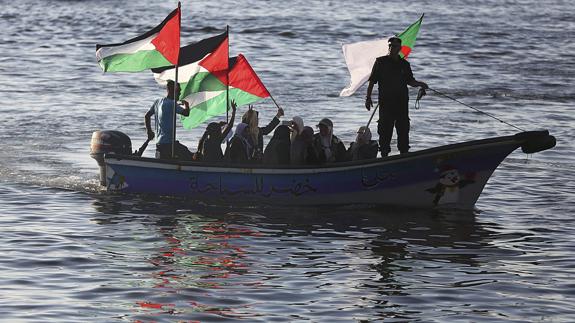Mujeres palestinas ondean su bandera nacional en solidaridad con la coalición 'Flotilla de la Libertad'. 