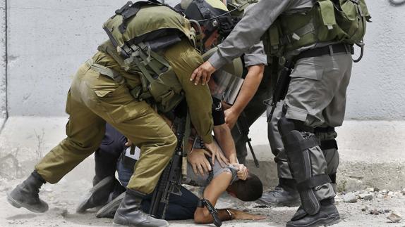 Soldados Israelíes, deteniendo a un joven palestino.