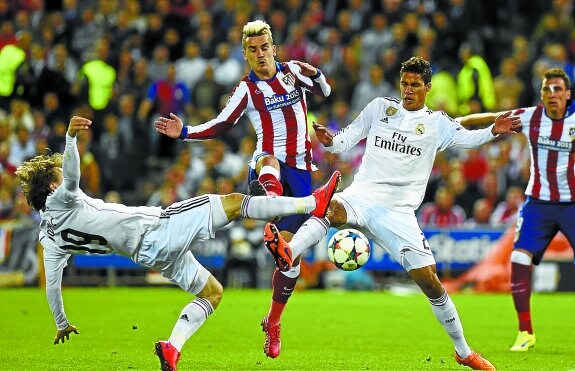 Griezmann lucha por un balón con Modric y Varane. 